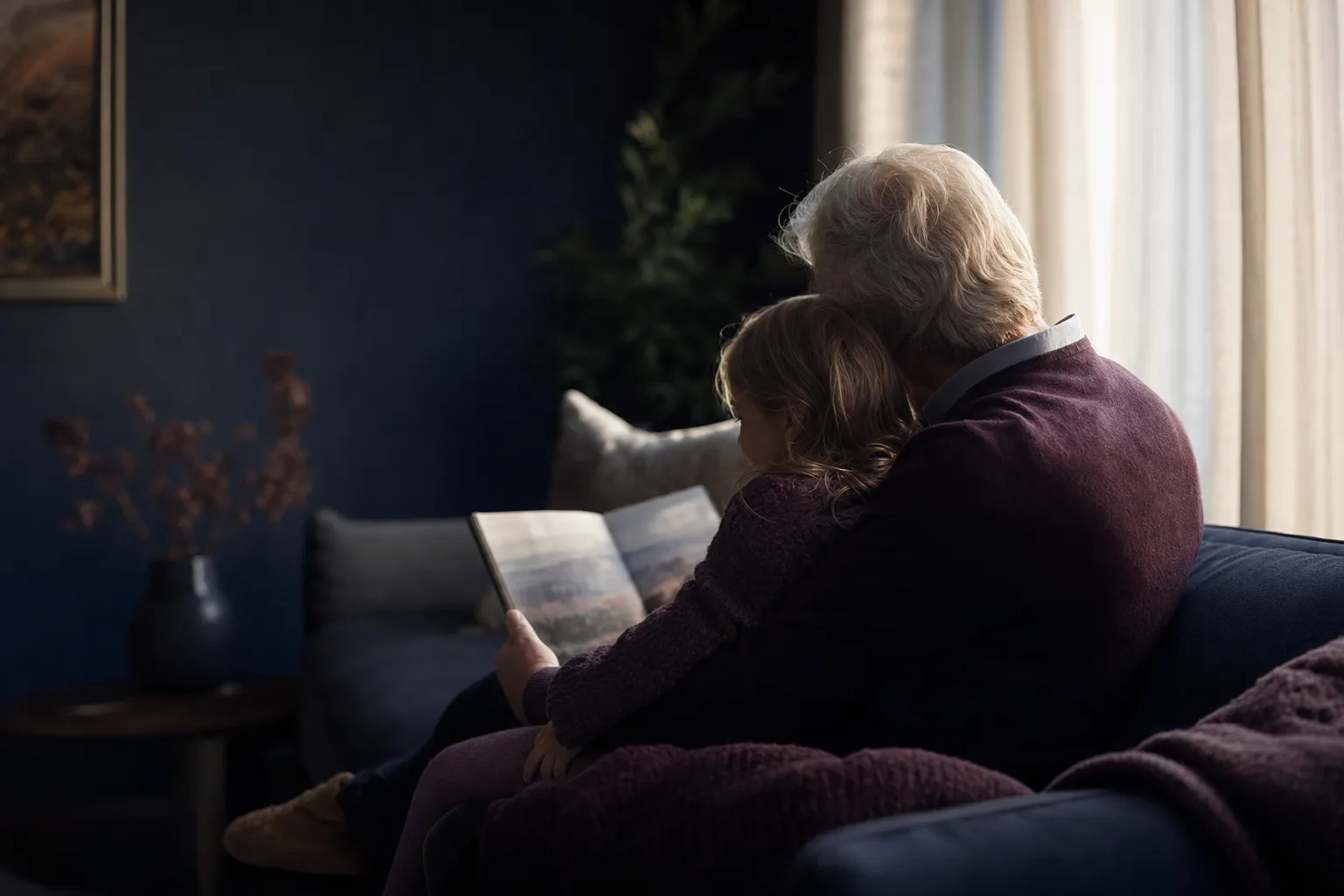 A grandparent and grandchild reading together at home, the kind of family a guardianship bond protects